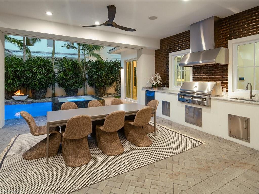 9185 Mercato Way Naples, FL 34108 - Photo 4 of 50 a view of a dining room with furniture a chandelier and wooden floor