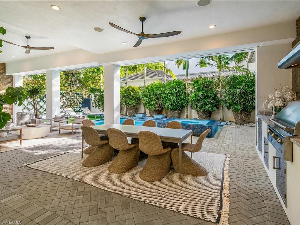 9185 Mercato Way Naples, FL 34108 - Photo 43 of 50 a living room with furniture and a large window