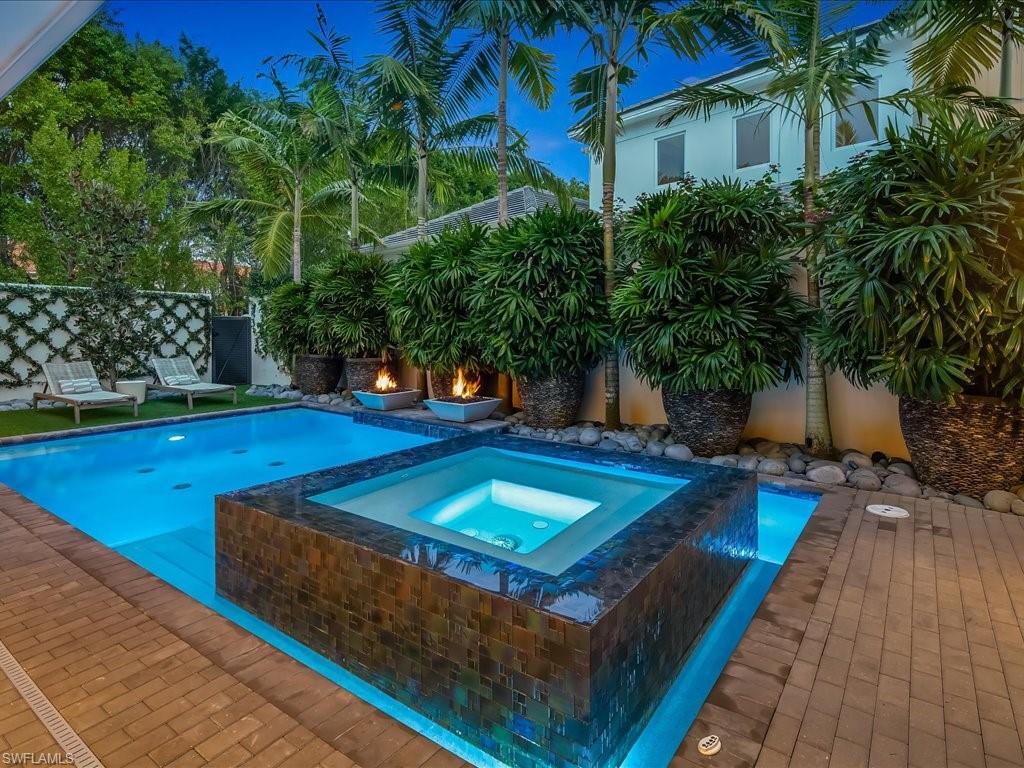 9185 Mercato Way Naples, FL 34108 - Photo 5 of 50 a view of a swimming pool with a lounge chairs
