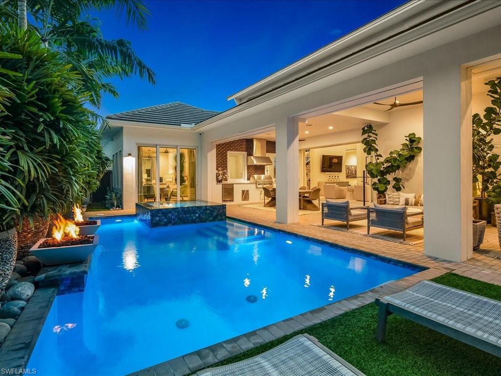 9185 Mercato Way Naples, FL 34108 - Photo 7 of 50 a view of swimming pool with an outdoor seating and yard