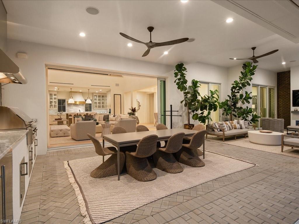 9185 Mercato Way Naples, FL 34108 - Photo 9 of 50 a living room with lots of furniture and a chandelier