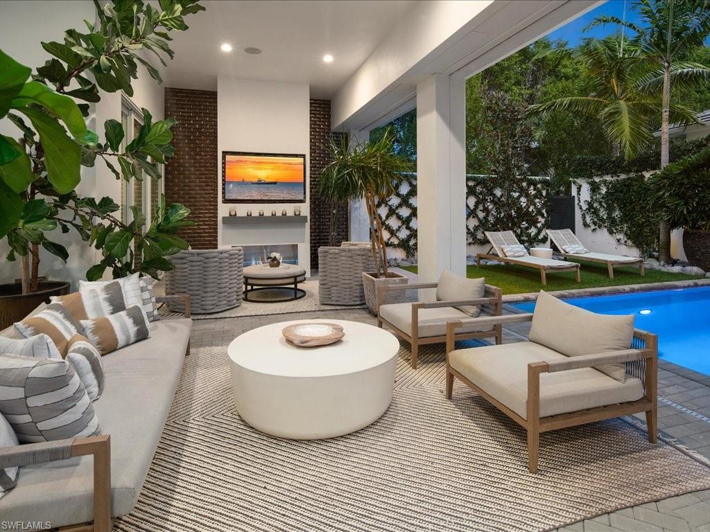 9185 Mercato Way Naples, FL 34108 - Photo 10 of 50 a living room with furniture a rug and a potted plant
