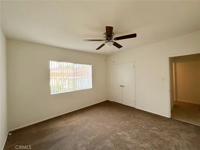 a view of room with a ceiling fan and window