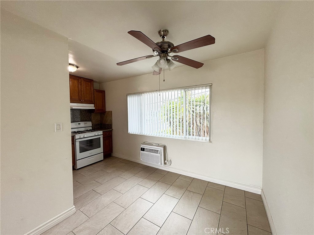 701 Adlena Drive, Unit 4 Fullerton, CA 92833 - Photo 7 of 14 a kitchen with stainless steel appliances a stove a sink and a refrigerator with white cabinets