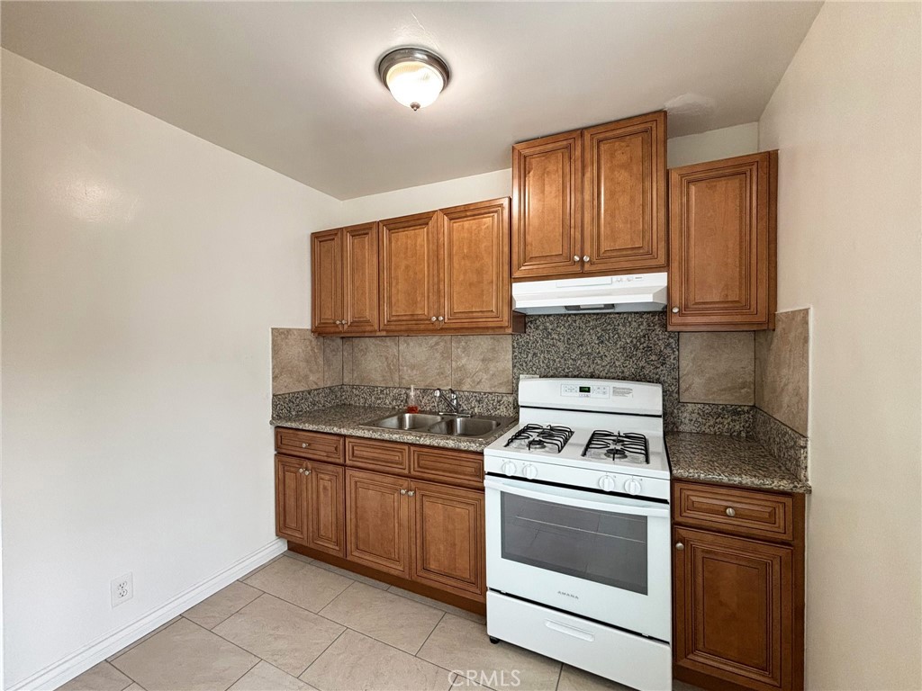 701 Adlena Drive, Unit 4 Fullerton, CA 92833 - Photo 8 of 14 a kitchen with a stove sink and cabinets