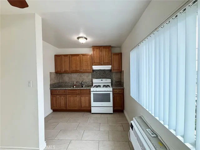 a kitchen with a stove top oven and sink