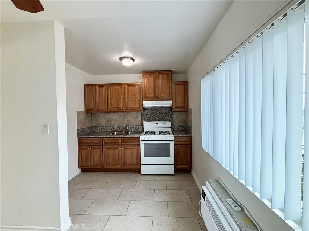 701 Adlena Drive, Unit 4 Fullerton, CA 92833 - Photo 9 of 14 a kitchen with a stove top oven and sink