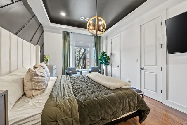 a bedroom with a bed and a chandelier