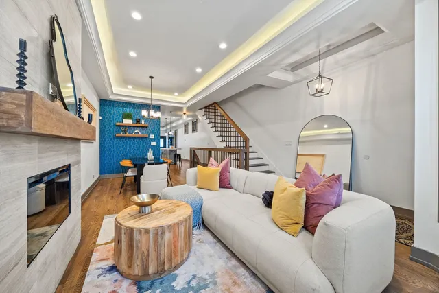 a living room with furniture a fireplace and a large window