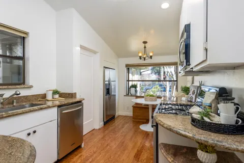 a kitchen with a table chairs stove and cabinets