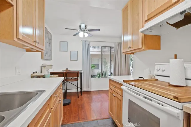 a kitchen with a stove a sink and a refrigerator