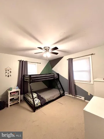 a bedroom with furniture and a window