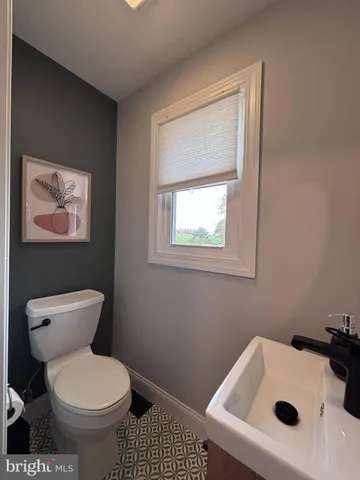 a white toilet sitting next to a bathroom sink