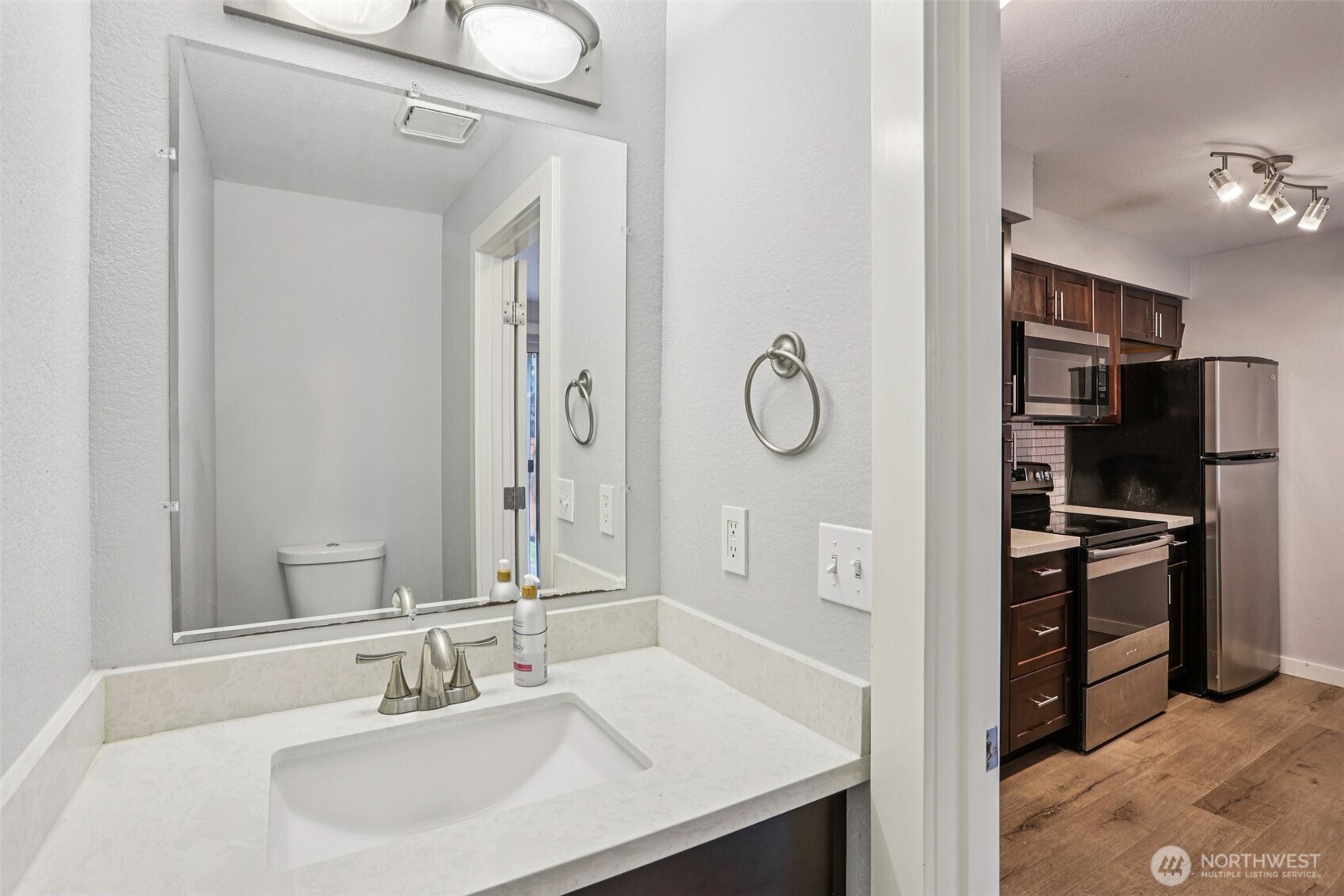 412 Center Road, Unit A1 Everett, WA 98204 - Photo 12 of 23 a bathroom with a sink a faucet a mirror and a shower