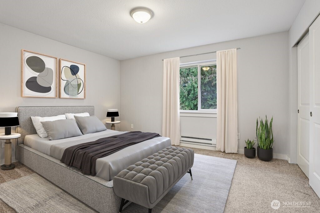 412 Center Road, Unit A1 Everett, WA 98204 - Photo 13 of 23 a bedroom with a bed and a potted plant