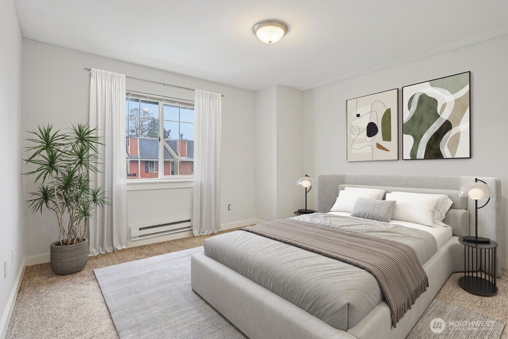 412 Center Road, Unit A1 Everett, WA 98204 - Photo 17 of 23 a bedroom with a large bed and a potted plant