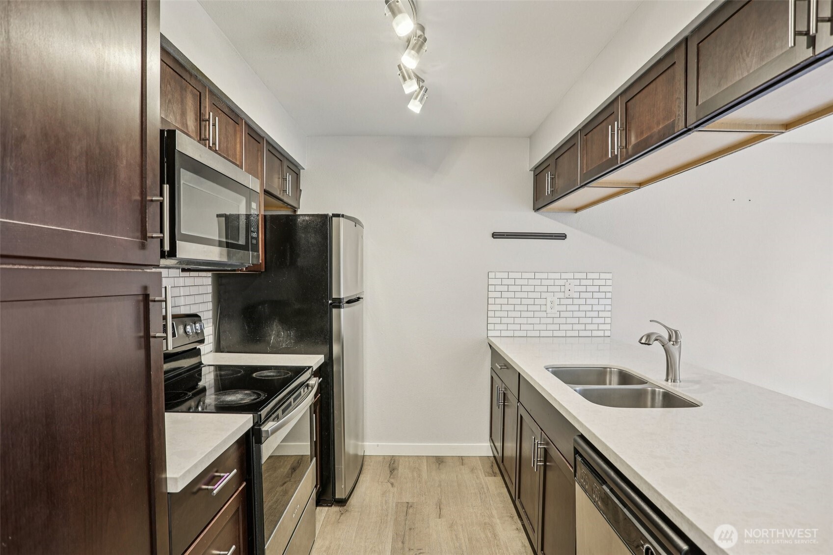 412 Center Road, Unit A1 Everett, WA 98204 - Photo 6 of 23 a kitchen with stainless steel appliances granite countertop a sink and a stove