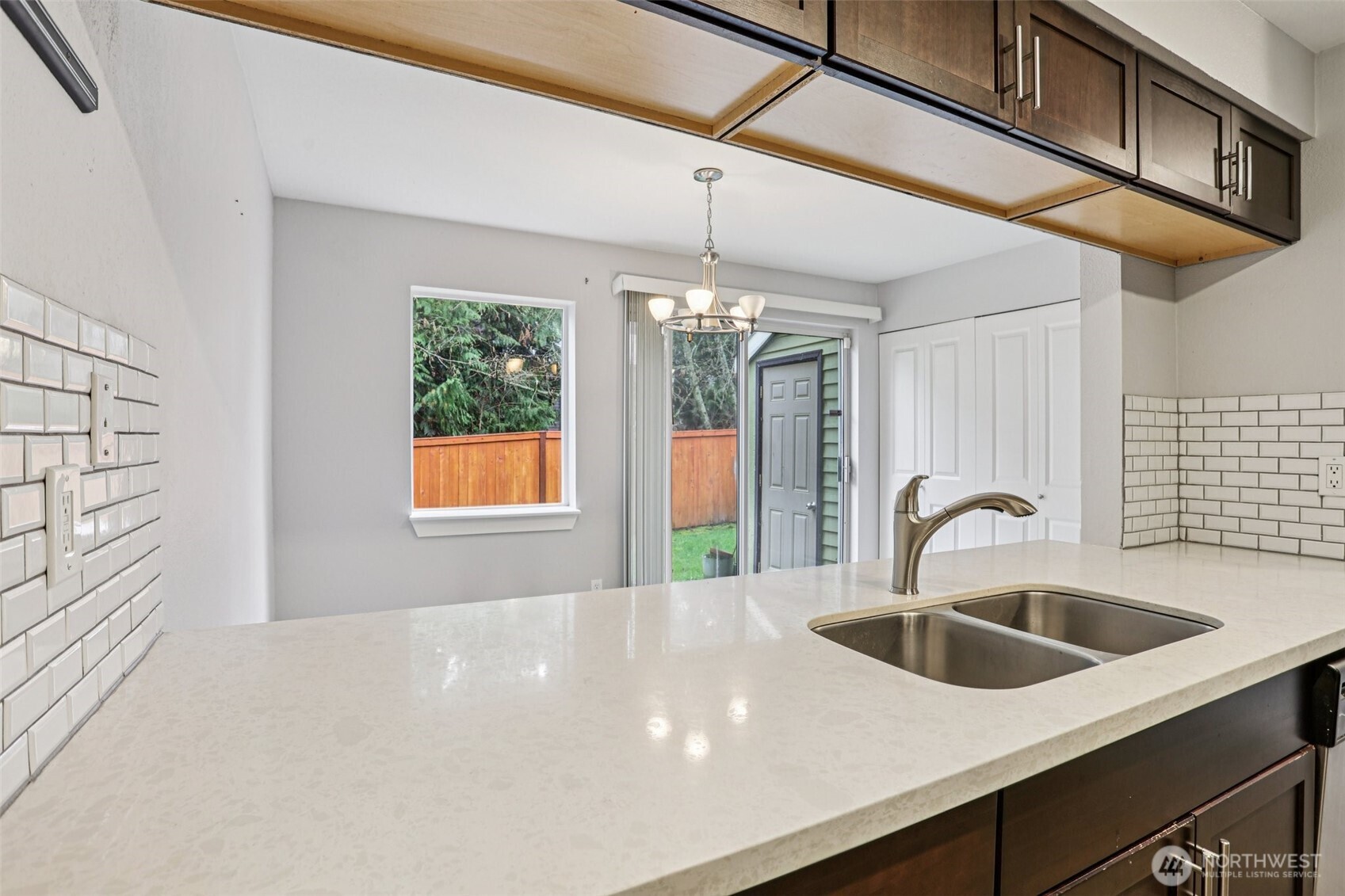 412 Center Road, Unit A1 Everett, WA 98204 - Photo 8 of 23 a kitchen with a sink and chandelier