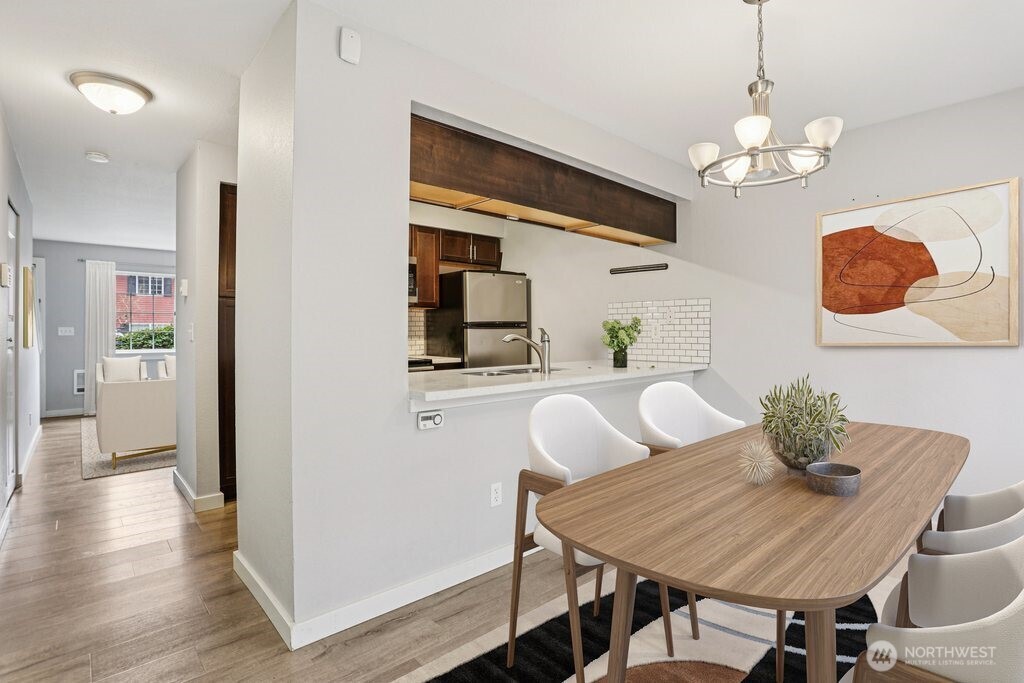 412 Center Road, Unit A1 Everett, WA 98204 - Photo 9 of 23 a view of a dining room with furniture wooden floor and chandelier