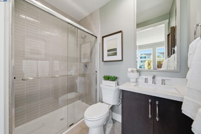 a bathroom with a bathtub shower sink mirror and toilet