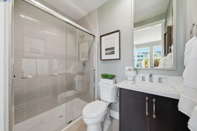 a bathroom with a bathtub shower sink mirror and toilet