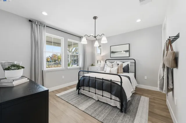 a spacious bedroom with a bed and a window