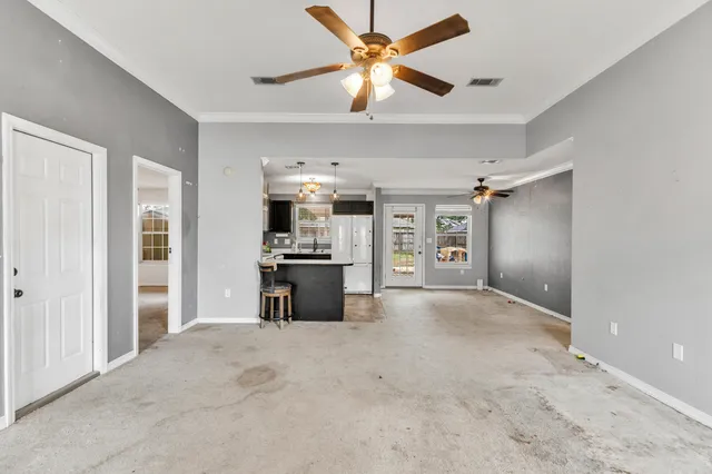 a view of a livingroom with a kitchen and a window