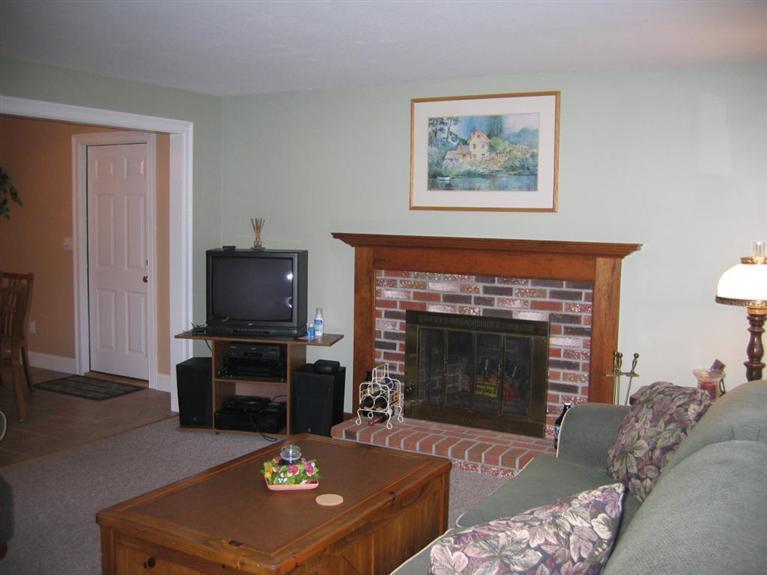 100 Ensign Road Centerville, MA 02632 - Photo 8 of 14 a living room with furniture a flat screen tv and a fireplace