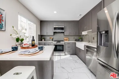 a kitchen with a sink cabinets and stainless steel appliances