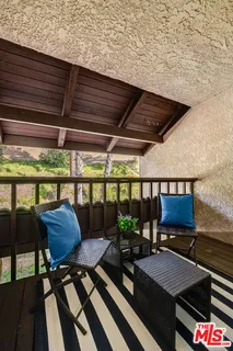 a outdoor living space with furniture and a potted plant