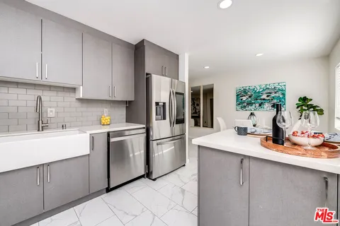 a kitchen with a sink appliances and cabinets