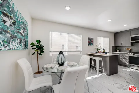 a view of a dining room with furniture window and flowerpot