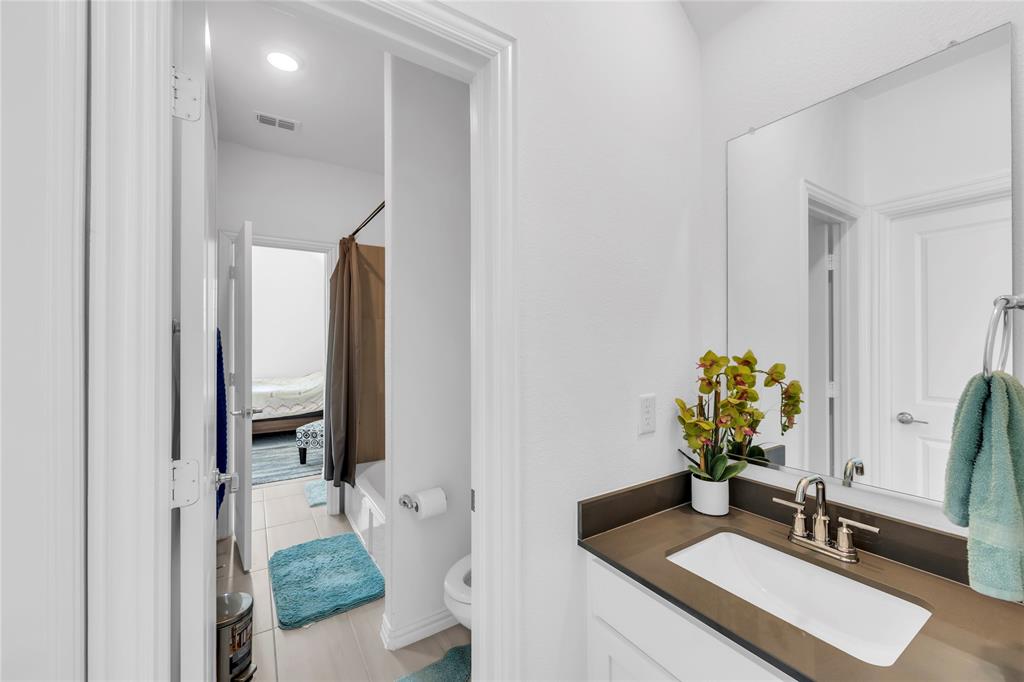 2218 Christopher Lane Euless, TX 76040 - Photo 13 of 28 a bathroom with a sink double vanity and a mirror