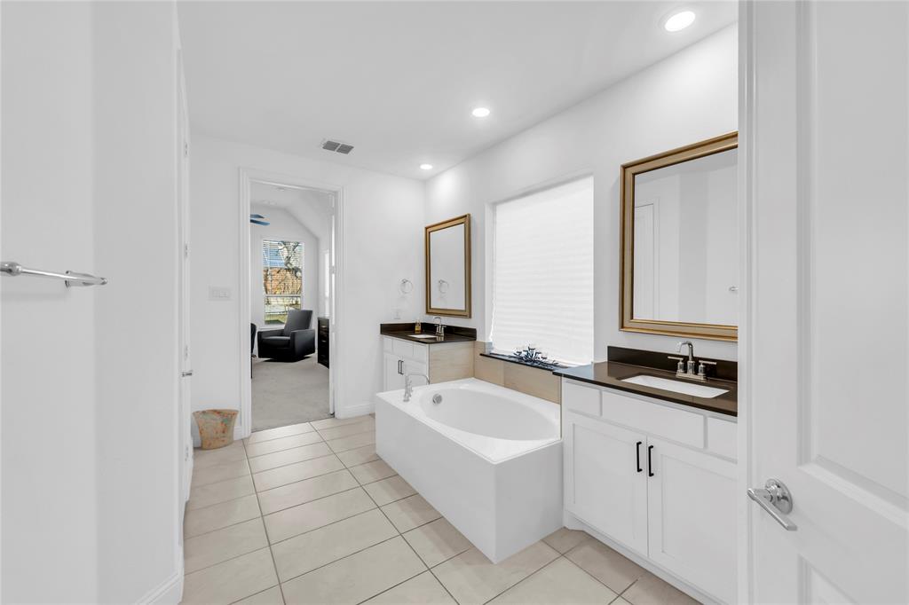 2218 Christopher Lane Euless, TX 76040 - Photo 14 of 28 a spacious bathroom with a bathtub and a sink