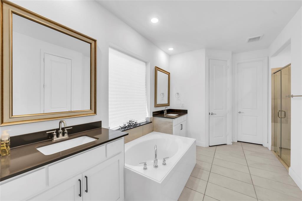 2218 Christopher Lane Euless, TX 76040 - Photo 15 of 28 a bathroom with a double vanity sink and mirror