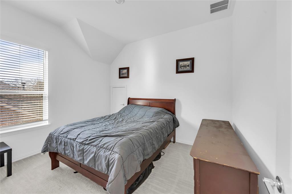 2218 Christopher Lane Euless, TX 76040 - Photo 18 of 28 a bedroom with a bed and a window