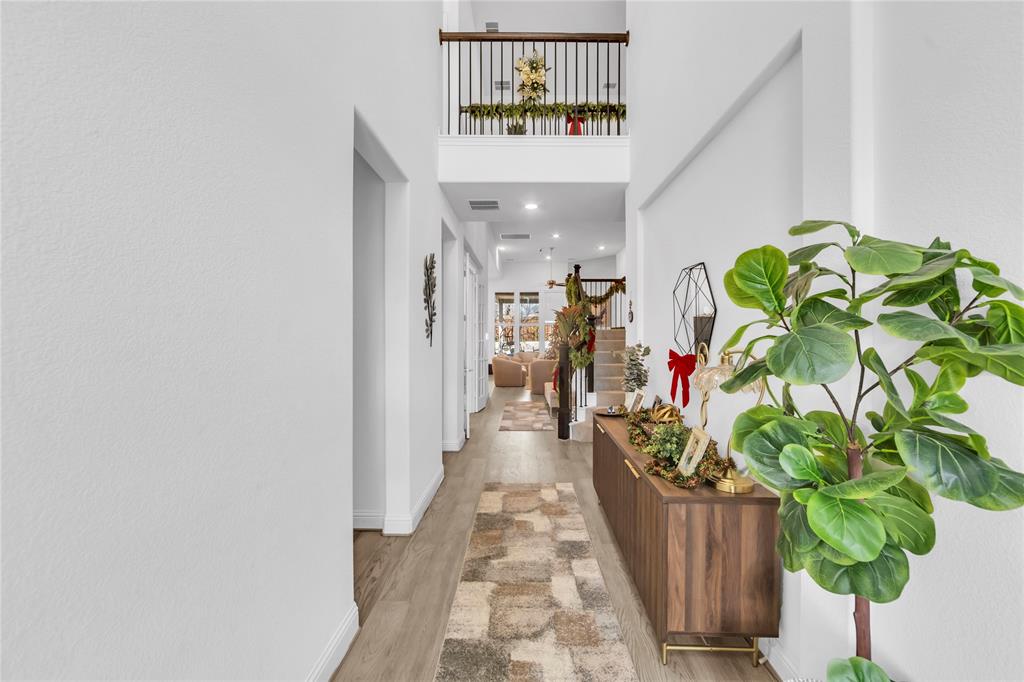 2218 Christopher Lane Euless, TX 76040 - Photo 3 of 28 a hallway with a vase of flowers
