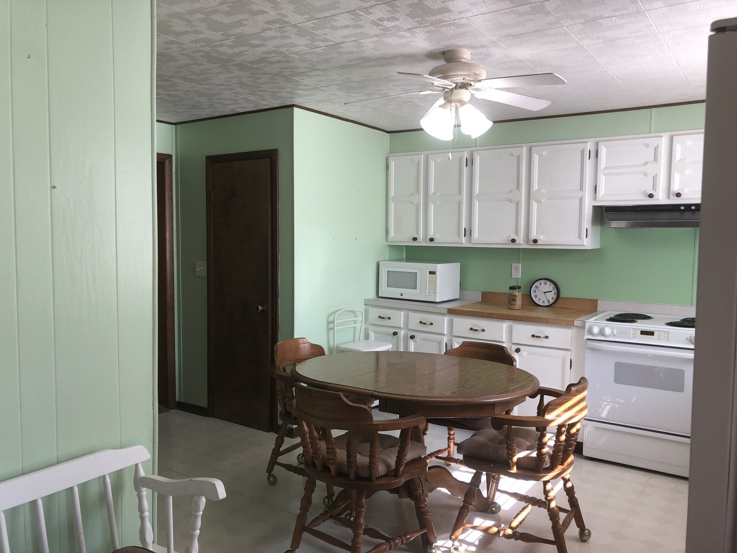 7968 South Sugar Island Road Chebanse, IL 60922 - Photo 18 of 39 a kitchen with a dining table chairs and white cabinets