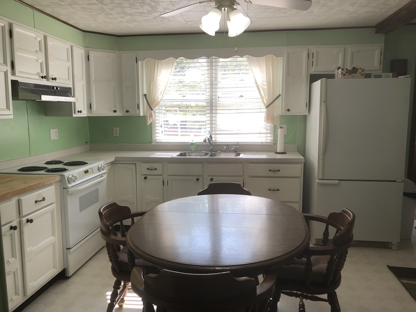 7968 South Sugar Island Road Chebanse, IL 60922 - Photo 19 of 39 a kitchen with stainless steel appliances granite countertop a sink a stove a refrigerator a dining table and chairs