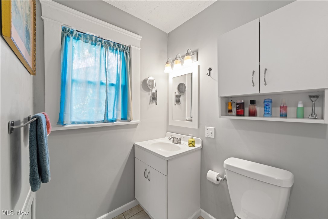 3024 Somerton Road Cleveland, OH 44118 - Photo 16 of 39 Half bath with vanity and tile patterned flooring
