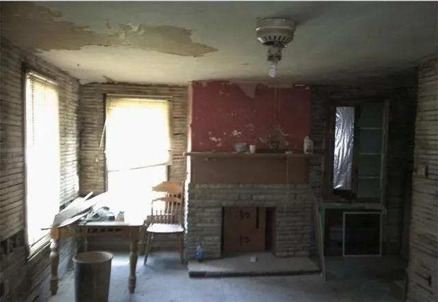 a dining room with a fireplace and chandelier