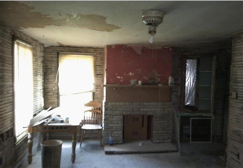 1746 Grange Road Charleroi, PA 15022 - Photo 2 of 11 a dining room with a fireplace and chandelier