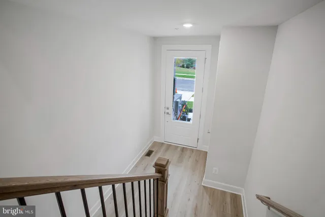 a bathroom with white cabinets a sink and a mirror