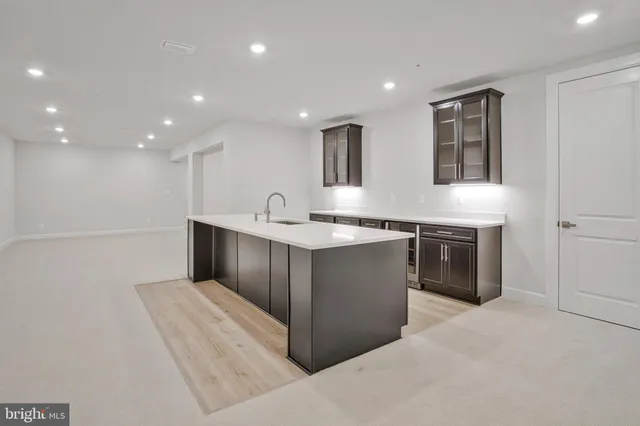 a view of a white house with large windows and a yard