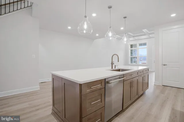 a kitchen with cabinets and stainless steel appliances