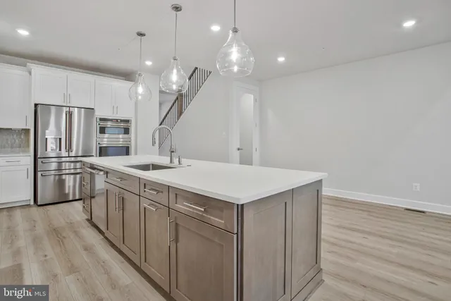 a stove top oven sitting inside of a kitchen