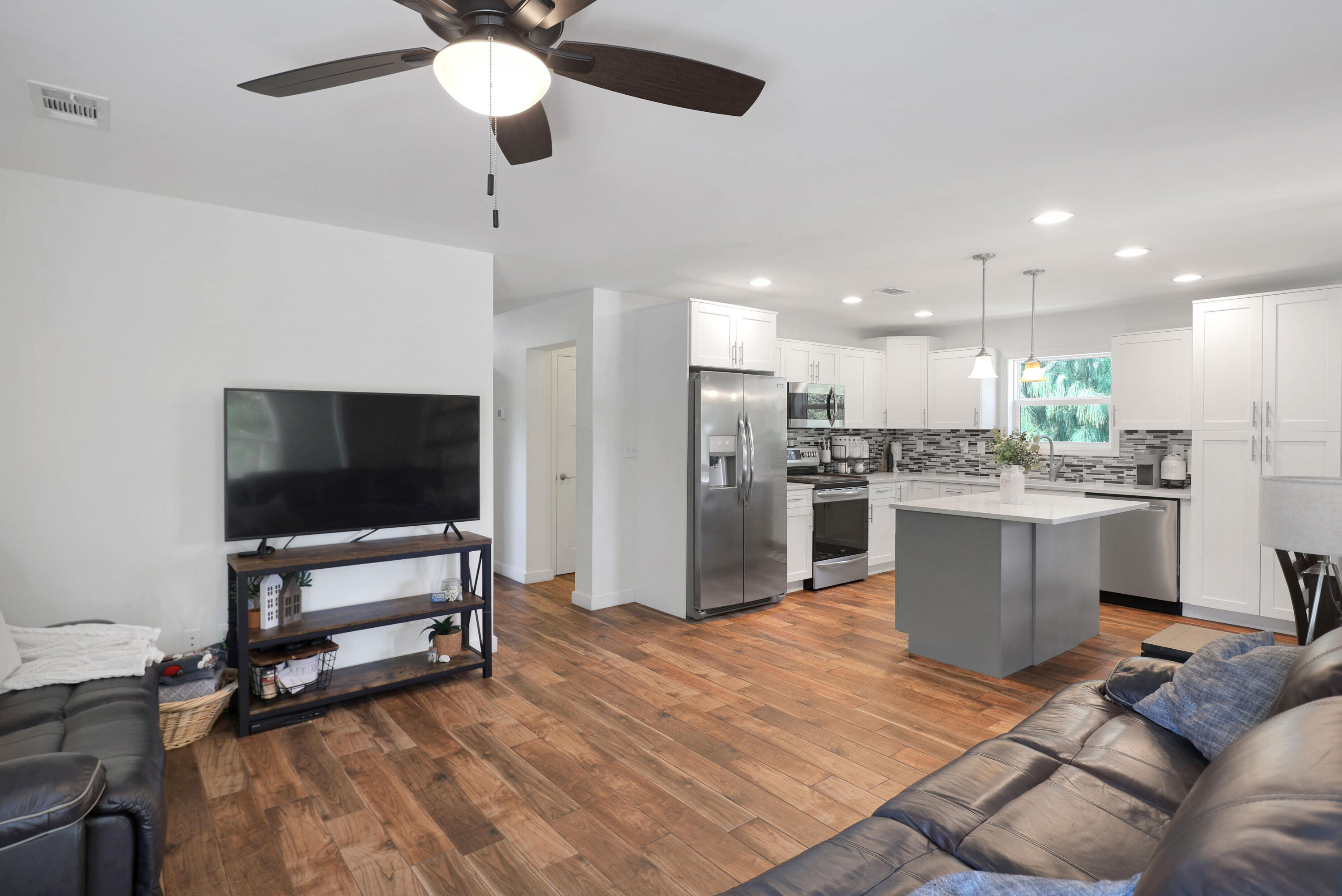 27087 Angel Fish Road Summerland Key, FL 33042 - Photo 13 of 32 a living room with stainless steel appliances kitchen island granite countertop furniture and a flat screen tv