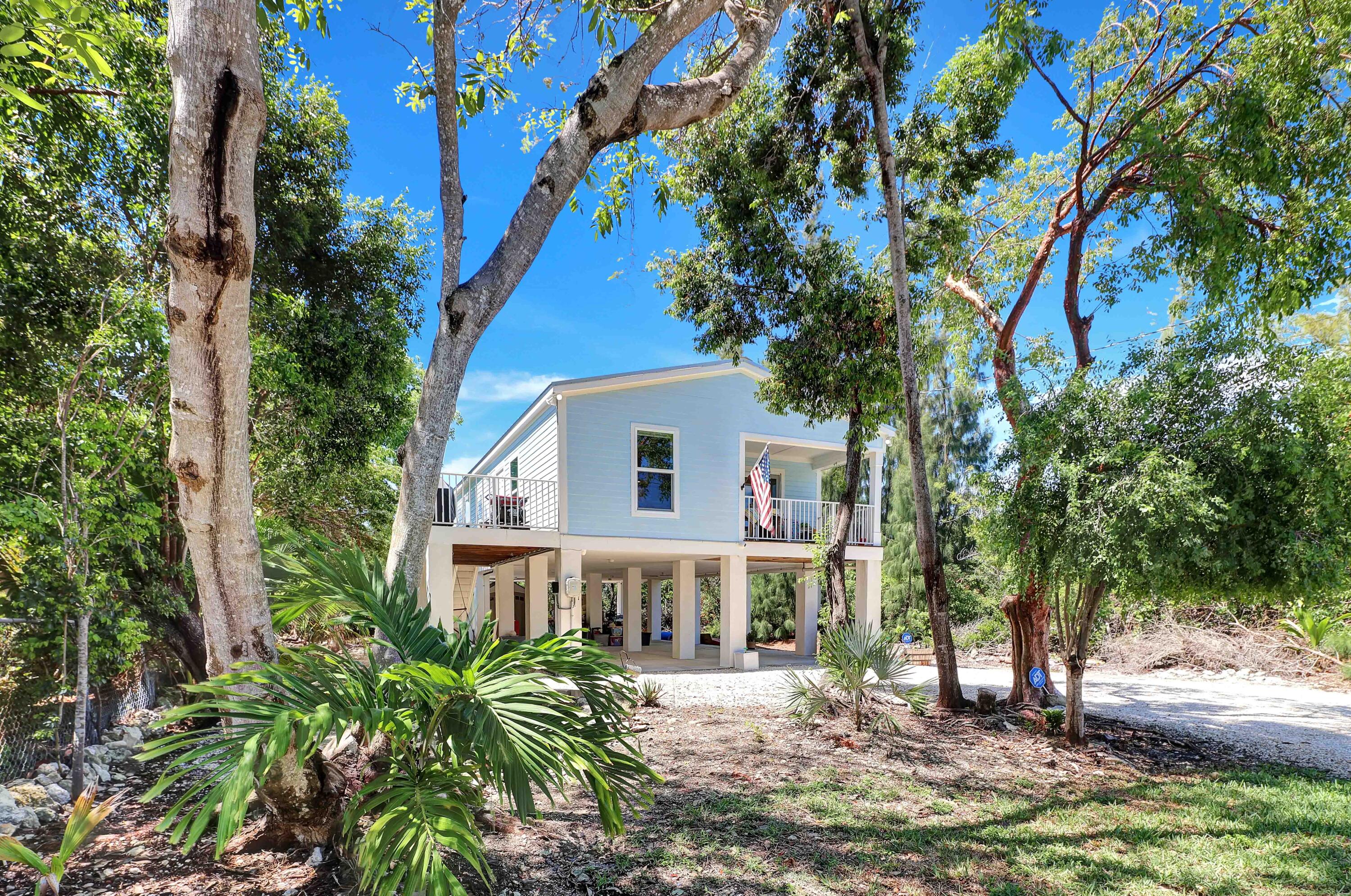 27087 Angel Fish Road Summerland Key, FL 33042 - Photo 2 of 32 a view of a house with a tree in front
