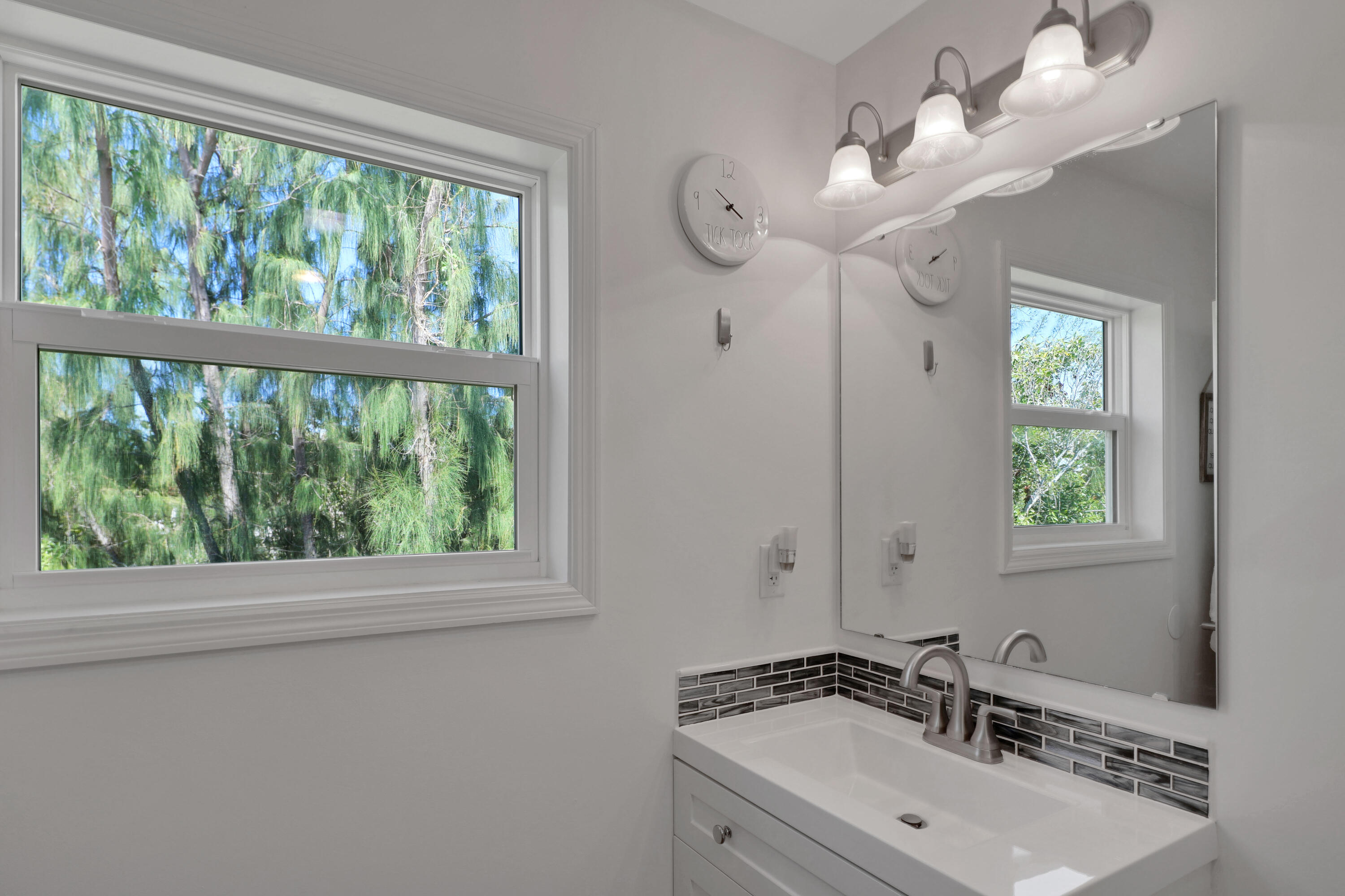27087 Angel Fish Road Summerland Key, FL 33042 - Photo 22 of 32 a bathroom with a sink a large mirror and a window