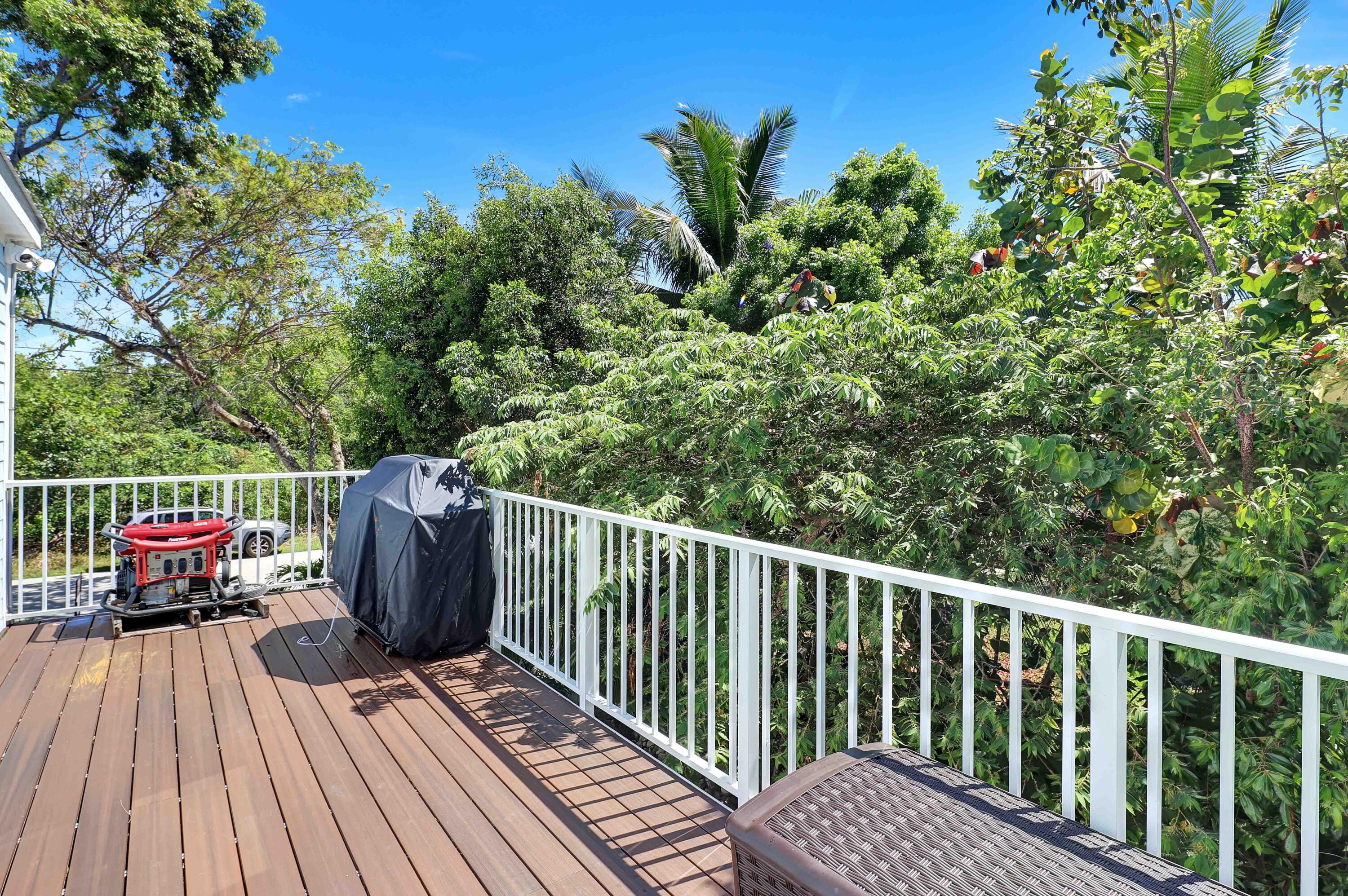 27087 Angel Fish Road Summerland Key, FL 33042 - Photo 26 of 32 a view of balcony with wooden floor and outdoor seating